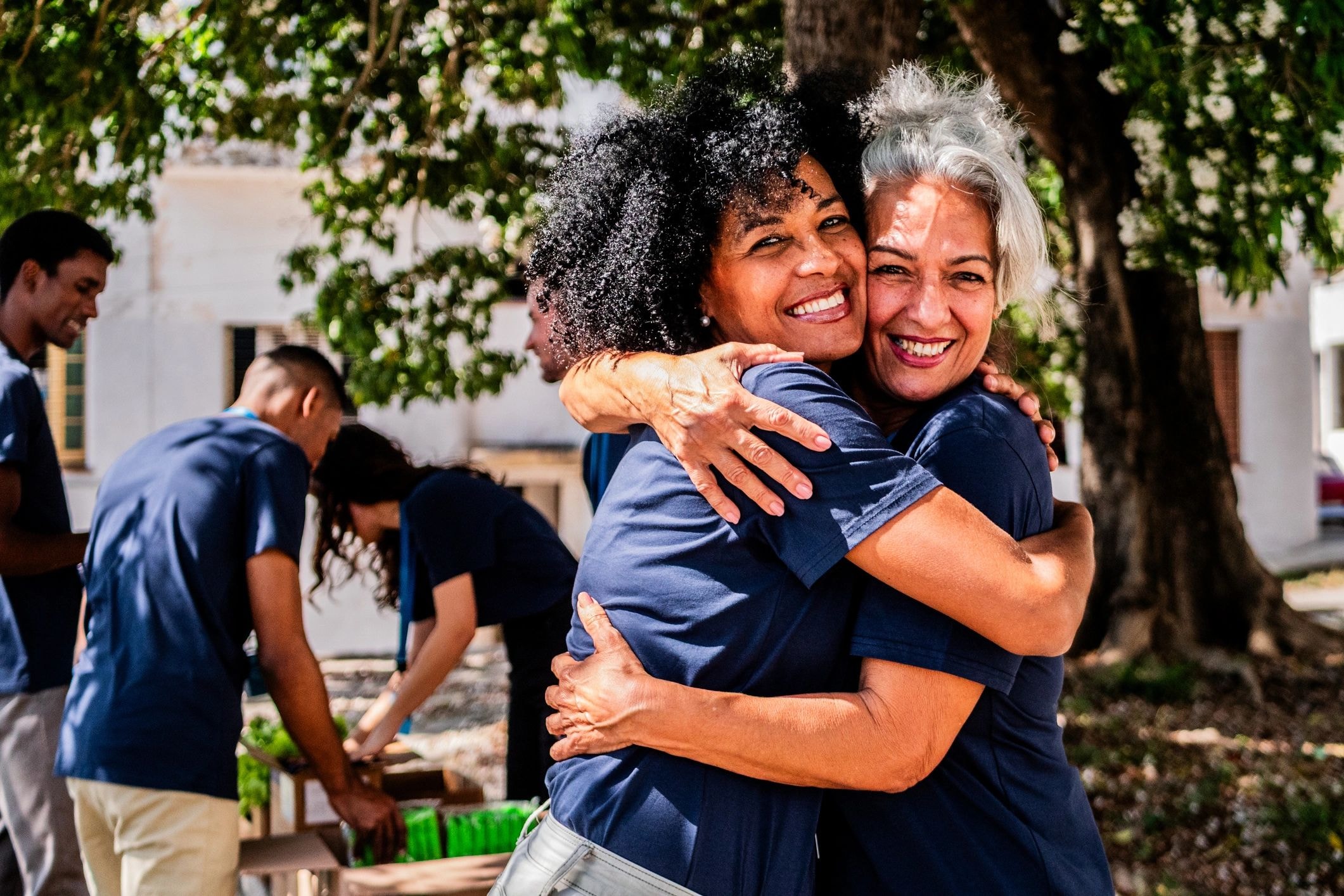 Two BCDC volunteers embracing at a community event